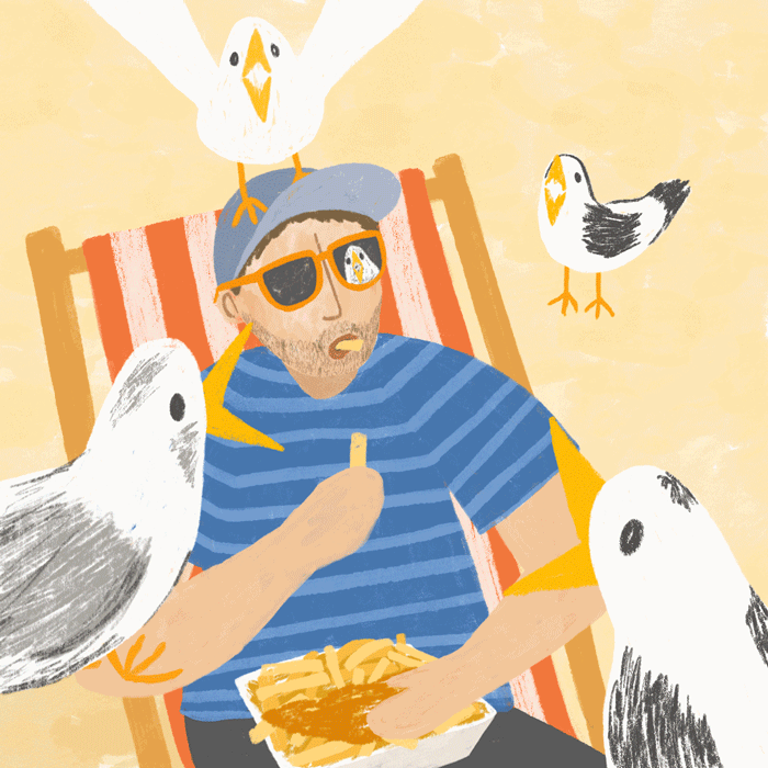 Person eating chips on the beach whilst seagulls look at him in envy