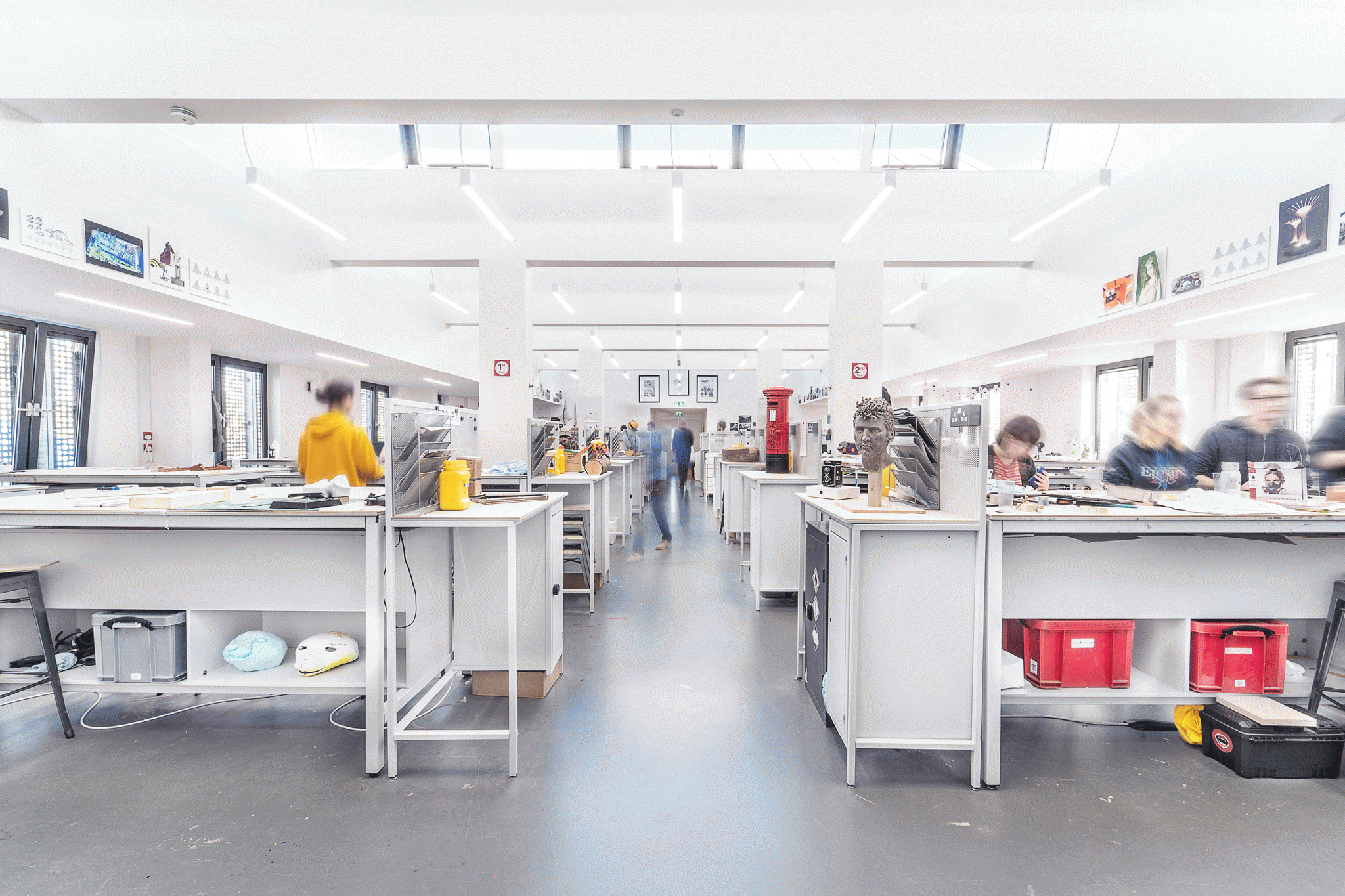 Rows of tables in a modelmaking studio; students are busy working behind the desks.